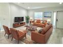 The living room features modern furniture and neutral décor, creating a cozy ambiance at 12390 Talavera St, North Port, FL 34287