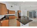 Spacious kitchen featuring stainless steel appliances, granite countertops, and tile floors at 15688 Melport Cir, Port Charlotte, FL 33981