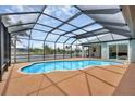 Enclosed pool with an extended view of the canal at 15688 Melport Cir, Port Charlotte, FL 33981