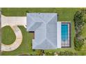 Overhead view of a home, highlighting the layout, long driveway and private backyard pool at 1726 Claw Ct, Venice, FL 34293