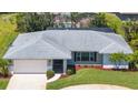 Charming single-story home featuring a solar panel roof, two car garage and well maintained landscaping at 1726 Claw Ct, Venice, FL 34293
