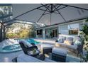 Relaxing screened patio with a lounge area and a luxurious pool and spa combination at 177 Ingram Blvd, Rotonda West, FL 33947
