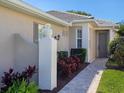 Beautiful home exterior featuring a decorative pineapple statue and a brick walkway to the front door at 1833 Lancashire Dr, Venice, FL 34293