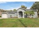 Attractive single-story home features a manicured lawn, two-car garage, and a welcoming entrance at 2038 Mincey Ter, North Port, FL 34286