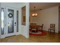 Inviting foyer with a decorative glass door and a view into the dining area at 20806 Valprato Ct, Venice, FL 34293