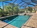 A stunning screened-in pool with clear water and a brick patio offers the perfect outdoor retreat at 20806 Valprato Ct, Venice, FL 34293