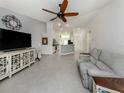Spacious living room with neutral tile flooring leading into an open concept kitchen at 2450 Sahara Ln, North Port, FL 34286