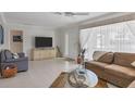 Bright living room featuring tile floors, neutral tones, and lots of natural light at 325 Fiesole St, Venice, FL 34285