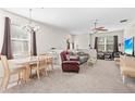 Comfortable living room featuring neutral carpeting, plenty of seating, and natural light from the windows at 3691 Parkridge Cir # 201, Sarasota, FL 34243