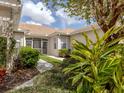 Charming beige home with a well-maintained lawn and a screened entryway for added privacy and curb appeal at 4123 Cascade Falls Dr, Sarasota, FL 34243