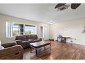 Inviting living room with wood floors, neutral walls, and a large window offering plenty of natural light at 427 Canterbury Rd, Venice, FL 34293