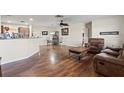 Open living space with wood floors, ceiling fan, and comfortable seating adjacent to the dining and kitchen areas at 427 Canterbury Rd, Venice, FL 34293