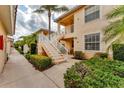 Inviting exterior view of a condo building with well-maintained landscaping and exterior staircase at 4433 Corso Venetia Blvd # C18, Venice, FL 34293
