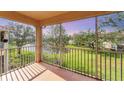 Scenic screened patio view overlooking a lush green space with a serene lake at 4433 Corso Venetia Blvd # C18, Venice, FL 34293