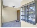 The entryway with a stone tile floor and a decorative window adds charm to the property at 503 Pine Hollow Cir # 503, Englewood, FL 34223