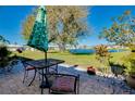 Relaxing outdoor patio with table, chairs, and a view of the pond, perfect for enjoying the scenery at 521 Circlewood Dr # Q11, Venice, FL 34293