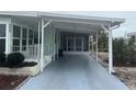 Exterior view of home with covered carport and screen enclosed porch at 524 S Cervina Dr, Venice, FL 34285