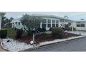 Exterior view of a well maintained home and landscaped yard with green grass at 524 S Cervina Dr, Venice, FL 34285