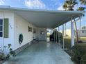 A covered parking area with storage leads to a side door entrance at 532 Via Veneto, Venice, FL 34285