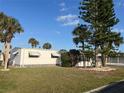 Cozy home featuring mature landscaping and classic awning accents at 532 Via Veneto, Venice, FL 34285