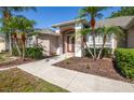 Inviting home entrance with a landscaped walkway and a well-manicured garden at 5824 Mckinley Rd, Venice, FL 34293