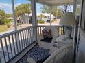 Relaxing screened porch with wicker furniture and a stylish outdoor rug at 601 Club House Rd, Venice, FL 34285