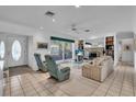 Bright living room with tile flooring, a fireplace, built-in shelving, and comfortable seating at 605 Valencia Rd, Venice, FL 34285