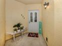 Inviting entryway featuring a decorative bench, 'Welcome' sign, and vibrant 'Hello' doormat at 632 Golf Dr # 632, Venice, FL 34285