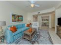Bright living room with comfortable blue sofa, stylish rug, and decorative accents at 632 Golf Dr # 632, Venice, FL 34285