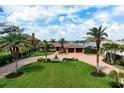 Beautiful single-Gathering home featuring meticulously maintained landscaping and circular driveway at 704 Laguna Dr, Venice, FL 34285