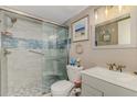 Comfortable bathroom with a tiled step-in shower and light and bright vanity and sink at 720 Apalachicola Rd # 104, Venice, FL 34285