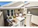 Private courtyard with comfortable seating, decorative planters, and brick-paved patio area at 782 Harrington Lake N Dr # 99, Venice, FL 34293