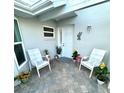 Inviting courtyard entrance featuring a brick-paved patio and seating area, creating a cozy welcome at 782 Harrington Lake N Dr # 99, Venice, FL 34293