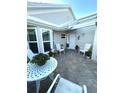 Charming courtyard features a brick-paved patio with a table and chairs, perfect for outdoor relaxation at 782 Harrington Lake N Dr # 99, Venice, FL 34293