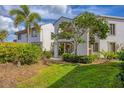 Condominium building featuring landscaping, a grassy lawn and a stairway entrance at 820 Capri Isles Blvd # 202, Venice, FL 34292