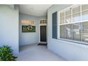 Charming entryway featuring decorative wreath, a large window and black front door at 835 Chalmers Dr # 835, Venice, FL 34293