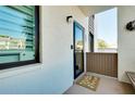 Charming condo front entrance with welcoming decor, including a decorative wreath and a cute doormat at 838 Bird Bay Way # 114, Venice, FL 34285