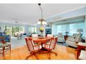 Inviting living room with a large dining table, comfortable seating, and bright natural light from large windows at 838 Bird Bay Way # 114, Venice, FL 34285