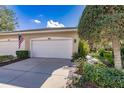 Attached two-car garage with a white door and an American flag displayed outside at 921 Tartan Dr # 31, Venice, FL 34293