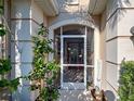 Close-up of the attractive, screened front door of the home, as well as a glimpse of the interior at 117 Altesino Ct, Venice, FL 34292