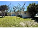 Charming one-story home featuring a well-maintained lawn and mature trees in a serene setting at 1170 Little Ct, Englewood, FL 34223