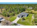 Charming single Gathering home with attached garage, well-manicured lawn, and landscaped front at 1207 Henning St, North Port, FL 34288