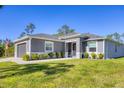 Beautiful single Gathering home boasts a well-manicured lawn and fresh landscaping at 1207 Henning St, North Port, FL 34288