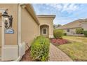 Inviting home entrance with brick walkway and landscaping, featuring the house number at 12198 Sebring Ln, Venice, FL 34293