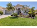 Charming single-story home featuring lush front lawn and meticulously landscaped garden beds at 142 Braemar Ave, Venice, FL 34293