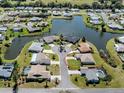 Aerial view of a lovely waterfront community surrounded by lush landscaping and serene lakes at 1602 Jim Jim Ct, Venice, FL 34293