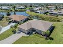 Aerial view of a charming single-Gathering home, surrounded by lush greenery and a tranquil waterfront at 1602 Jim Jim Ct, Venice, FL 34293