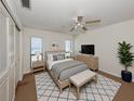 Comfortable bedroom featuring a ceiling fan, neutral decor, and ample natural light at 1602 Jim Jim Ct, Venice, FL 34293