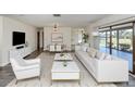 Bright living room with neutral color palette, modern furnishings, and view of the outdoors at 1602 Jim Jim Ct, Venice, FL 34293