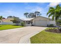 Well-maintained single-story home featuring a metal roof and manicured landscaping at 201 Cavallini Dr, Nokomis, FL 34275